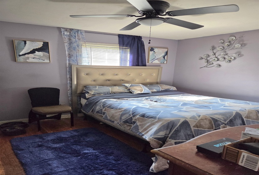 Bedroom featuring wood finished floors and ceiling fan
