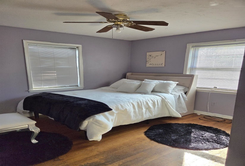 Bedroom with wood finished floors and a ceiling fan