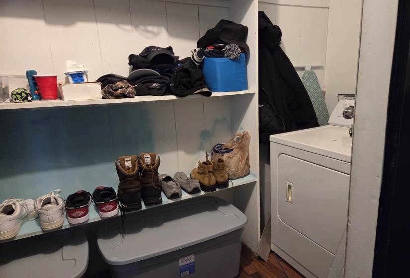 Laundry area featuring washer / dryer and dark wood-style flooring