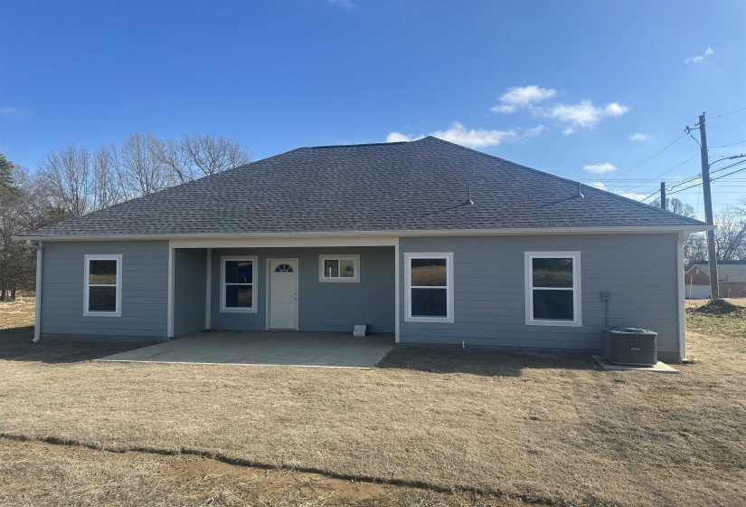 Rear view of house with cooling unit, a yard, and a patio