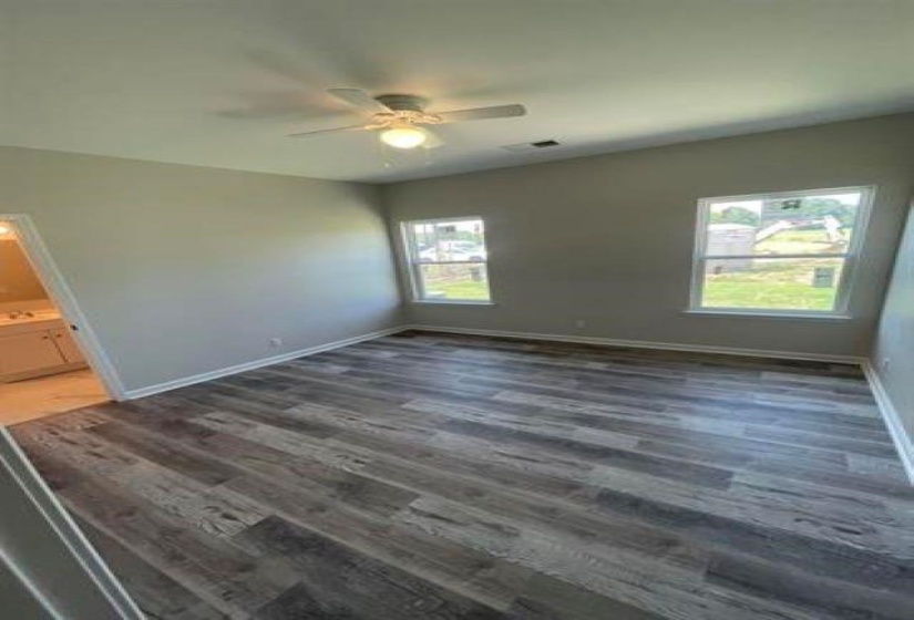 Spare room featuring ceiling fan and dark hardwood / wood-style flooring
