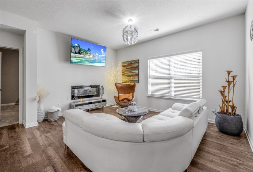 Living room with dark wood-style flooring and a textured ceiling