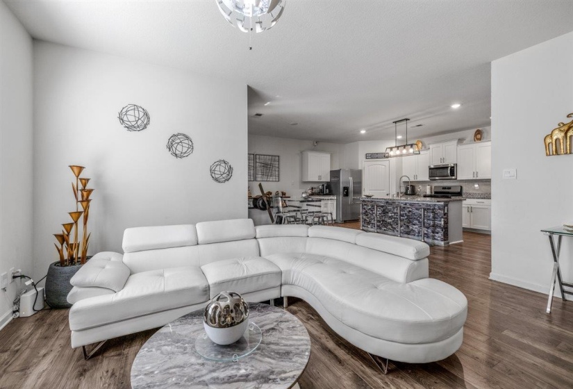 Living room with dark wood-style floors and recessed lighting