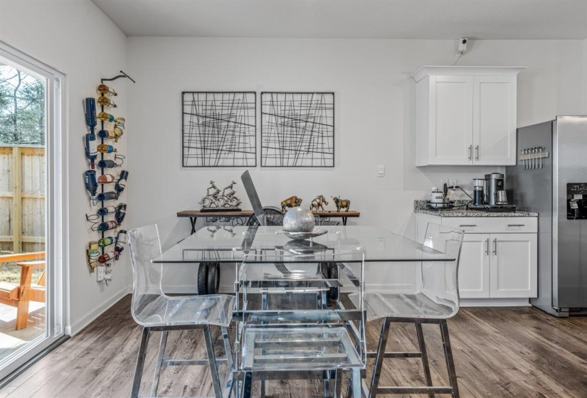 Dining space with light wood-style floors and baseboards