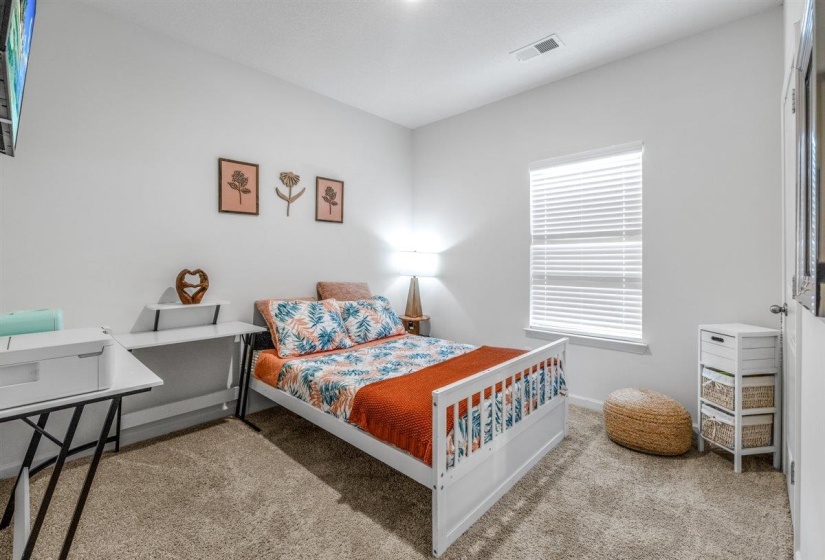 Bedroom with light carpet and baseboards