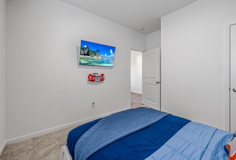 Carpeted bedroom featuring baseboards