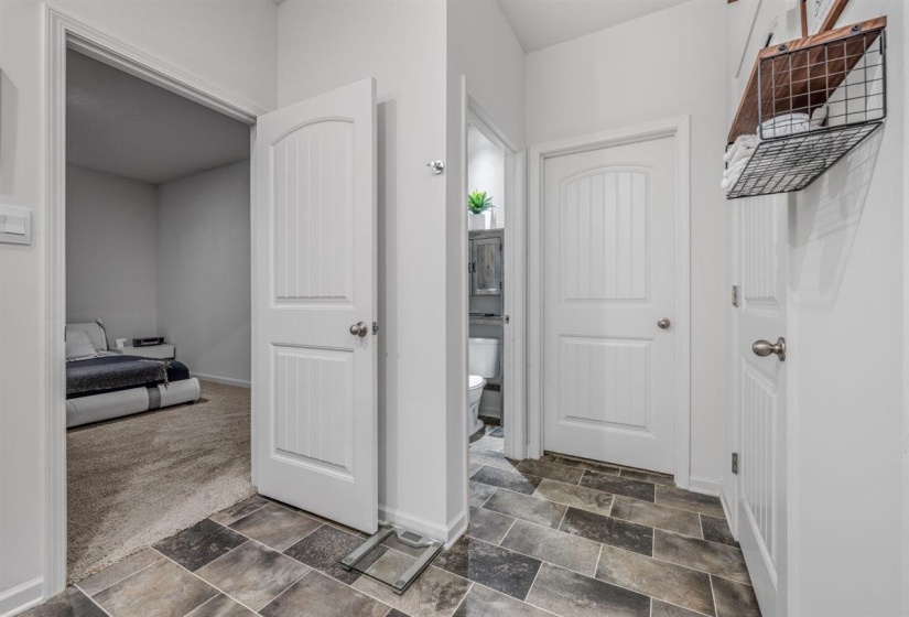 Bathroom featuring stone finish flooring, dark carpet, and ensuite bath