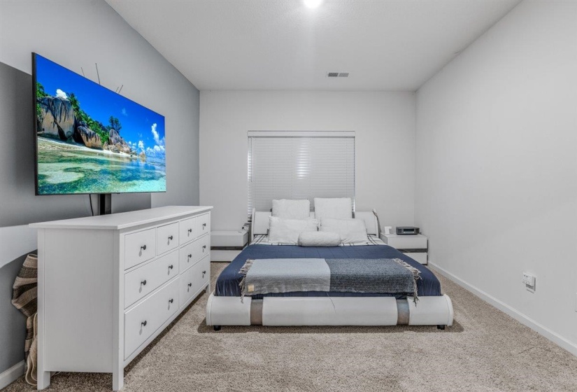 Bedroom featuring light carpet