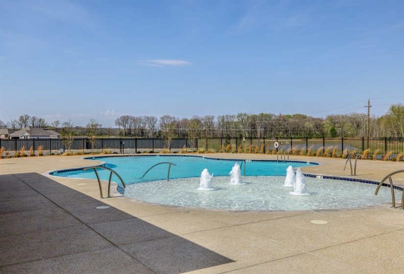 Community pool with a patio