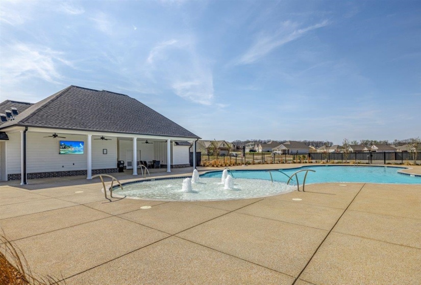 Community pool with a patio area and a residential view