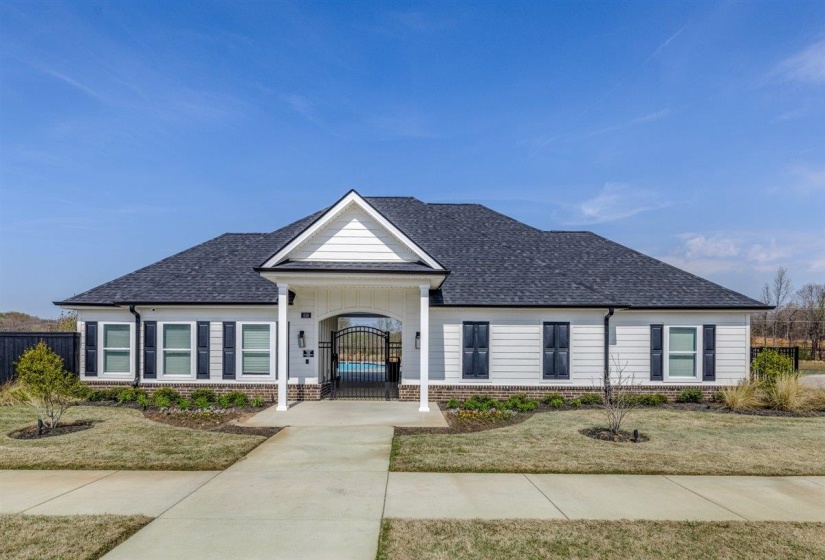 View of front of house featuring a porch, brick siding, a shingled roof, and a gate