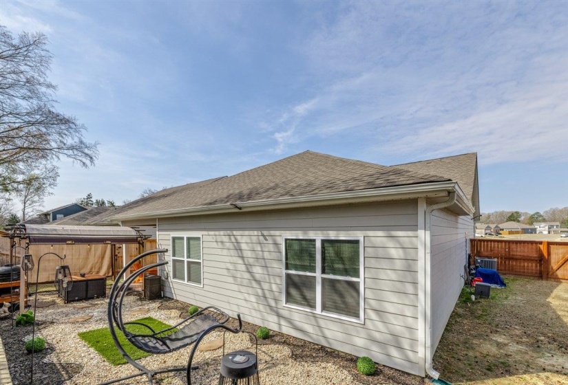 Rear view of property with a fenced backyard and roof with shingles