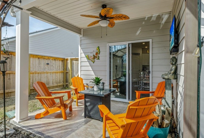 Sunroom / solarium with a ceiling fan and a patio