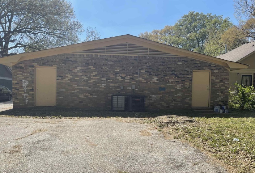 View of property exterior with a central AC unit and brick siding