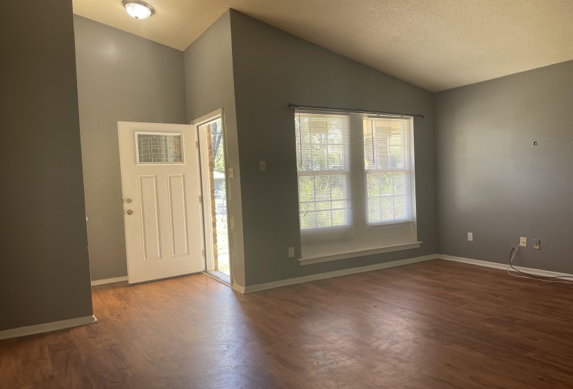Entryway with dark wood-style flooring and plenty of natural light