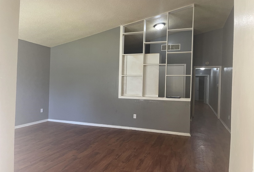 Unfurnished room with dark wood finished floors and baseboards