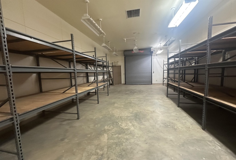 Storage area with a garage and visible vents