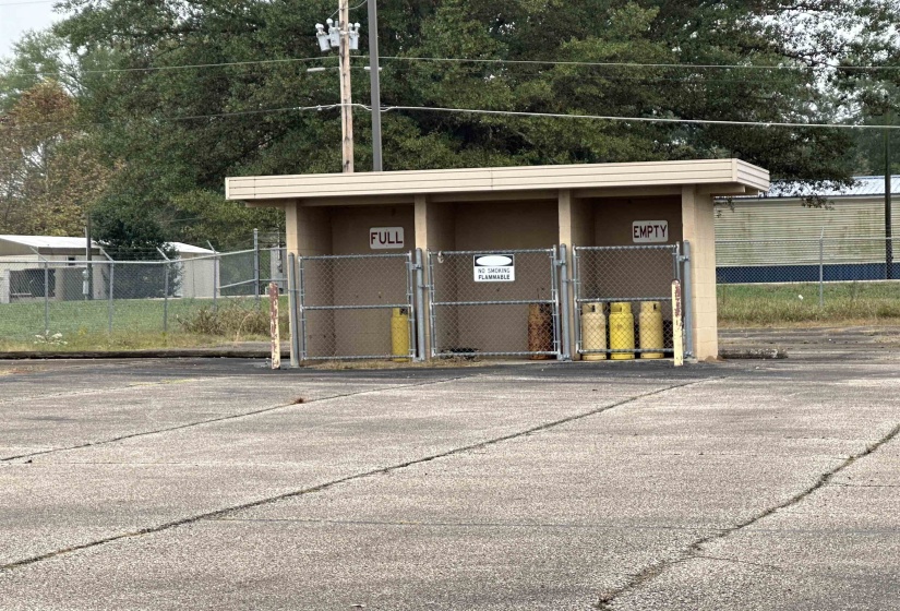 View of outdoor structure featuring a gate and fence
