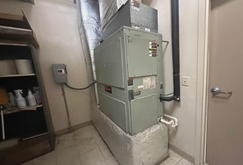 Utility room featuring heating unit