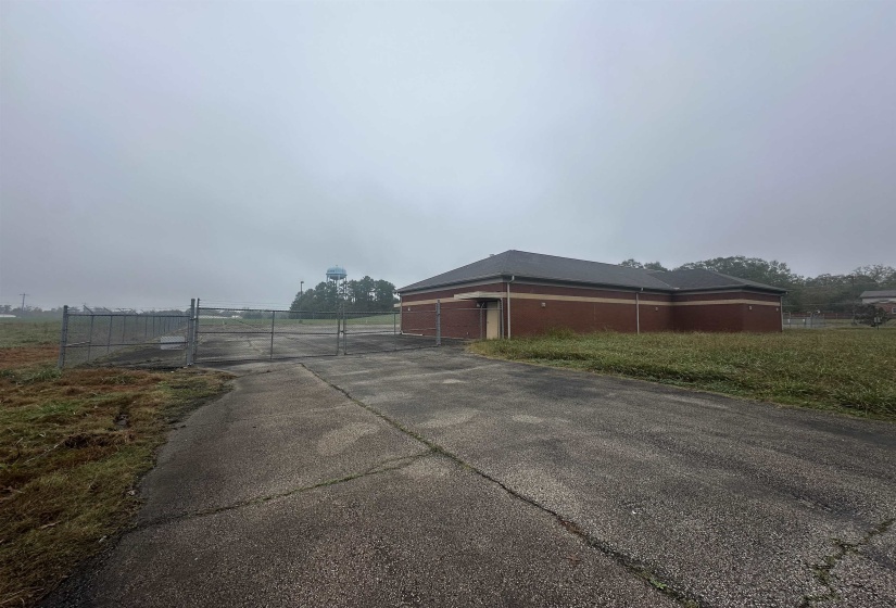 View of road featuring driveway, a gate, and a gated entry