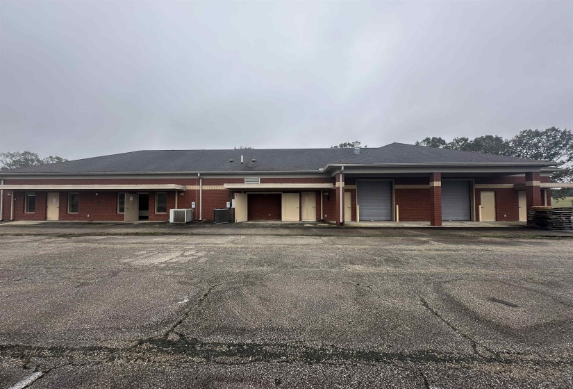 View of back of property featuring brick siding and central AC