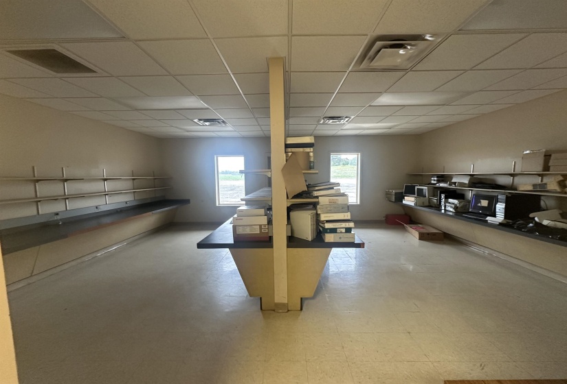Below grade area with visible vents, a drop ceiling, and tile patterned floors