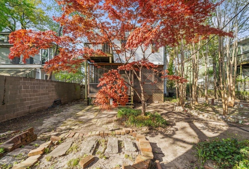 View of yard featuring a sunroom and a patio