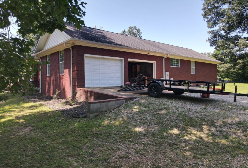 Brick exterior with white siding accents and a dark shingle roof