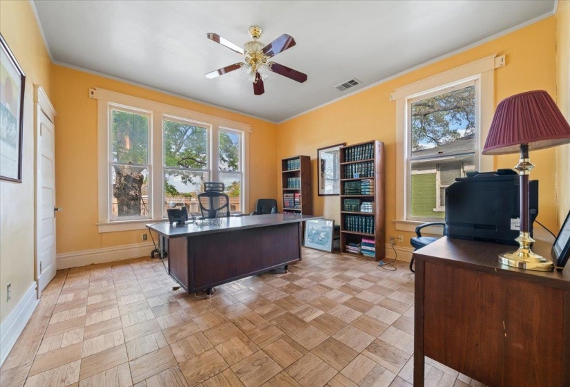 Office area featuring ceiling fan, ornamental molding, and parquet floors