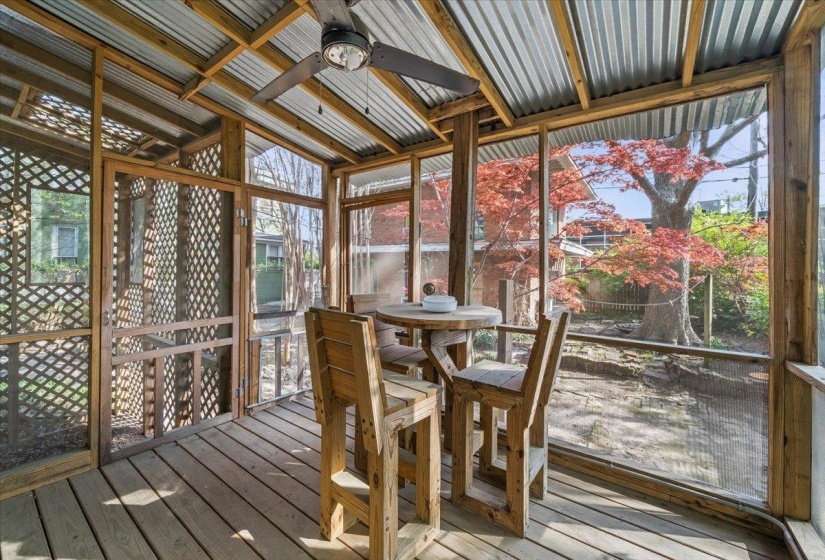 Sunroom / solarium with ceiling fan and a wooden deck