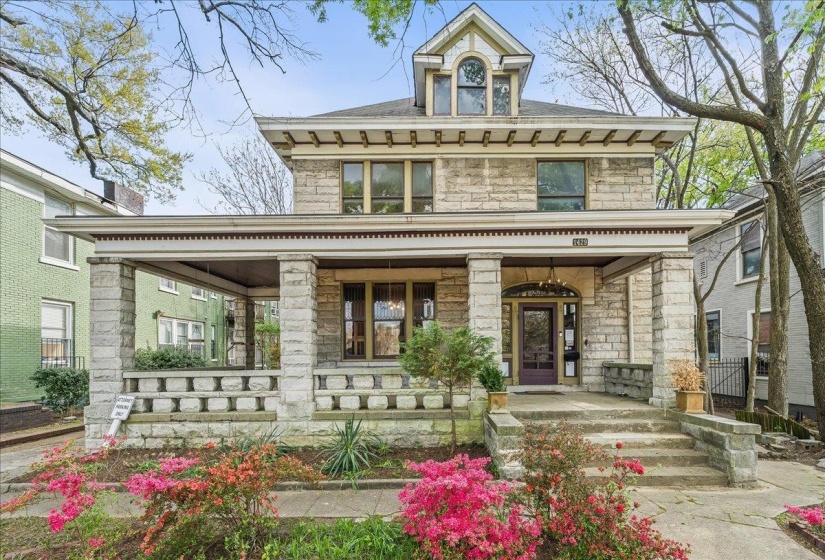 View of front of house featuring stone siding and covered porch