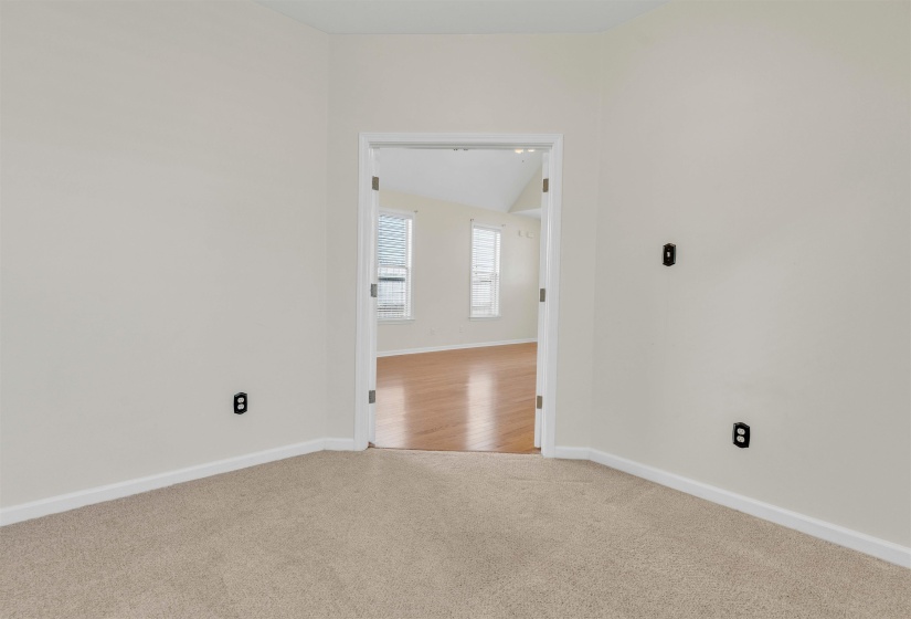 Carpeted empty room with baseboards