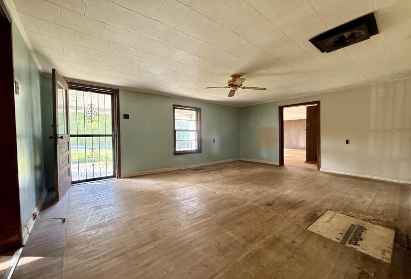 Empty room featuring hardwood / wood-style flooring and ceiling fan