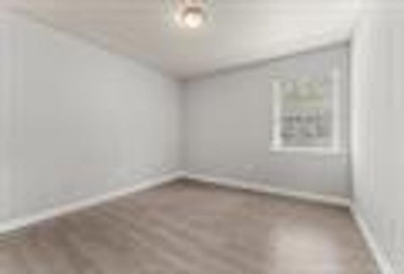 Spare room featuring baseboards