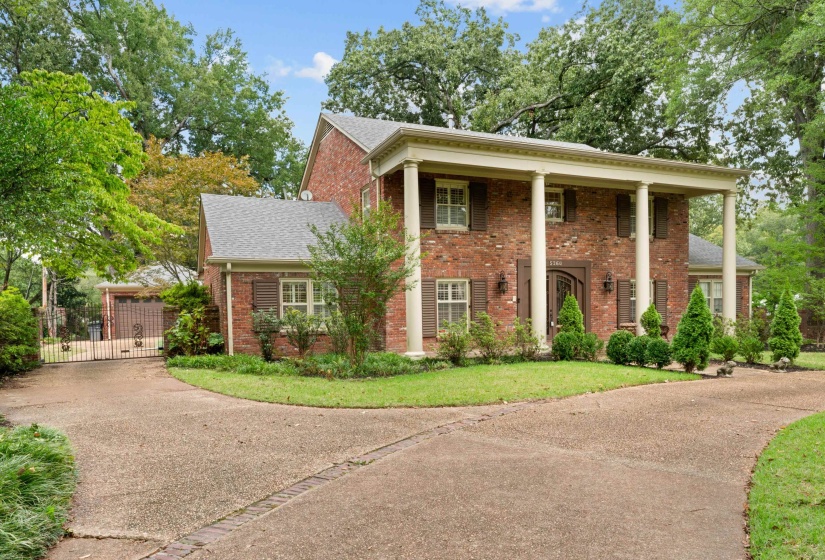 View leading to 3 car garage behind automatic gates