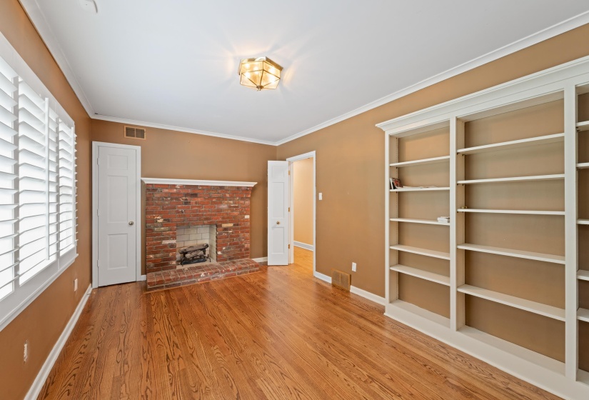 Bedroom or 2nd floor living room/office. Gas fireplace, a wealth of natural light, refinished oak floors and built-in bookcases
