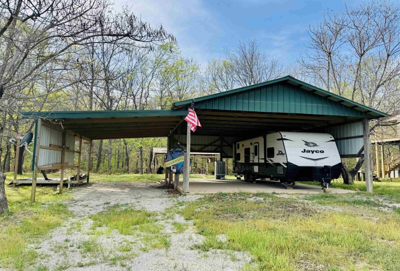 View of parking for more than one RV. There is a 30 ft wide driveway to help ease maneuvering your RV into the covered area.