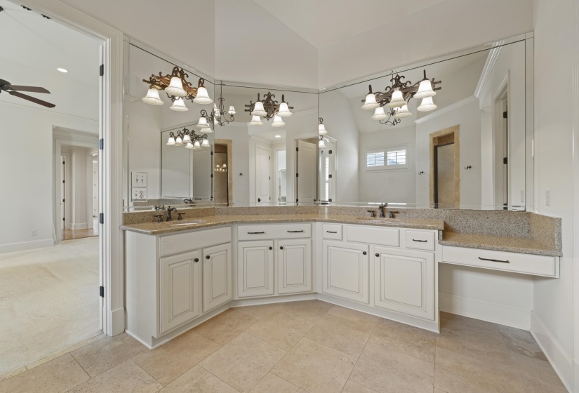 Bathroom featuring double vanity, suspended lighting, vaulted ceiling, and ceiling fan