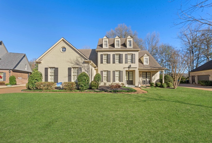 Colonial inspired home featuring a front yard and covered porch