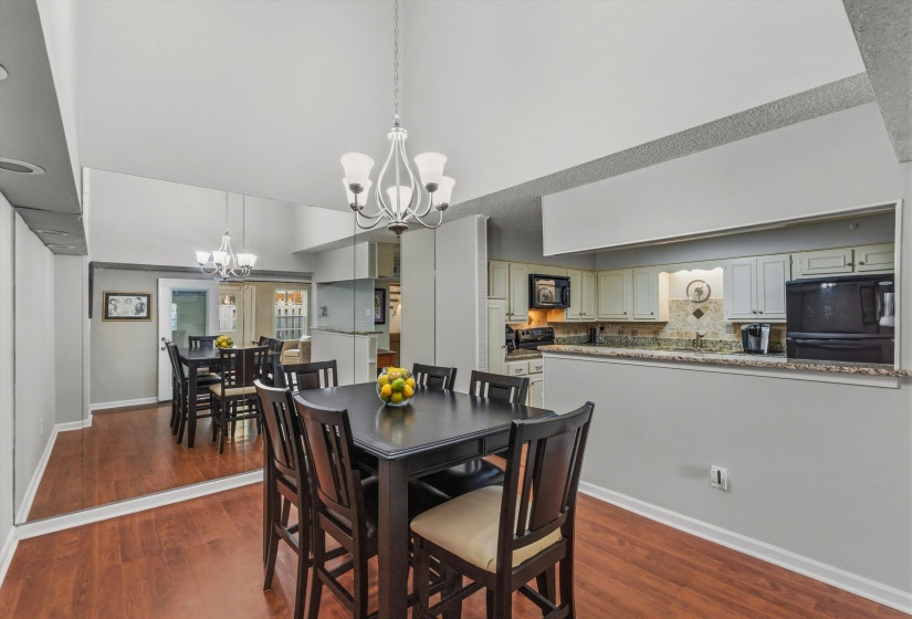 Dining space featuring a chandelier and dark wood-style flooring