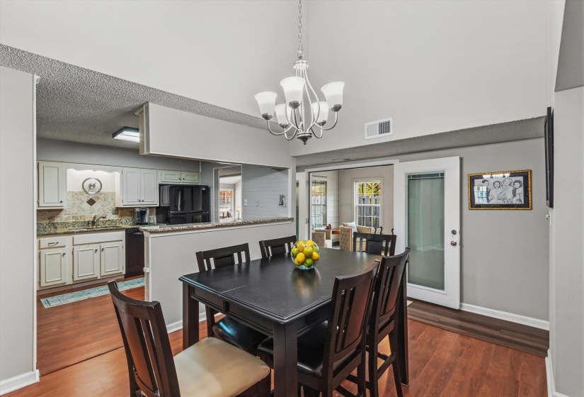 Dining room featuring a chandelier and dark wood-type flooring