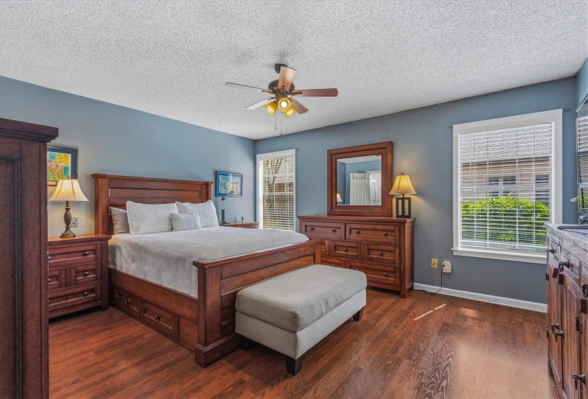 Bedroom featuring dark wood finished floors, a textured ceiling, and ceiling fan