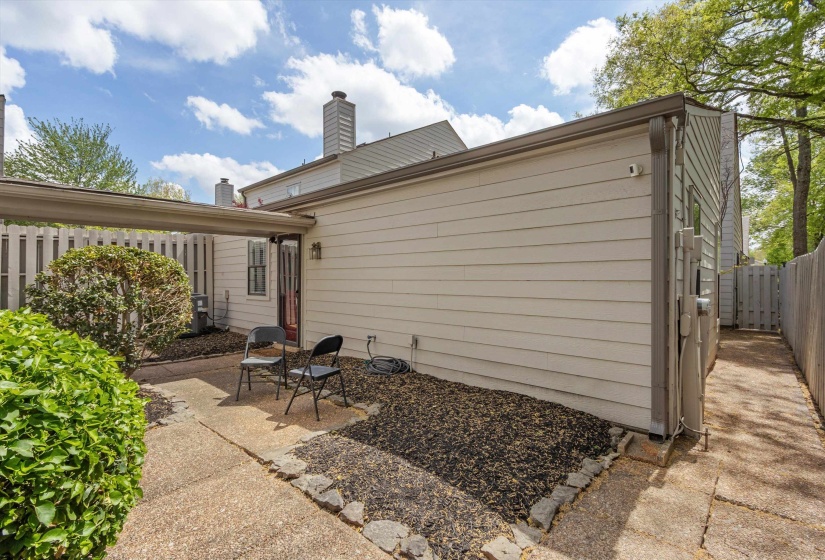 Back of property with a fenced backyard, a patio area, and a chimney
