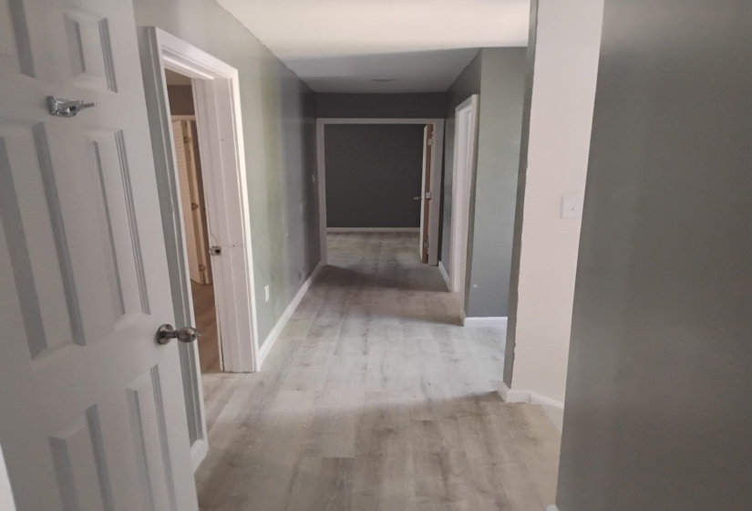 Hall featuring baseboards and light wood-style floors
