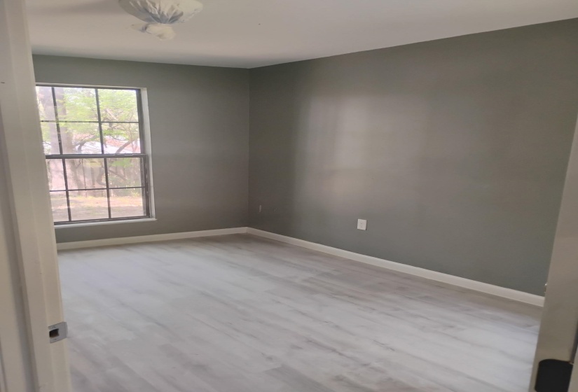 Unfurnished room with light wood-style floors and baseboards
