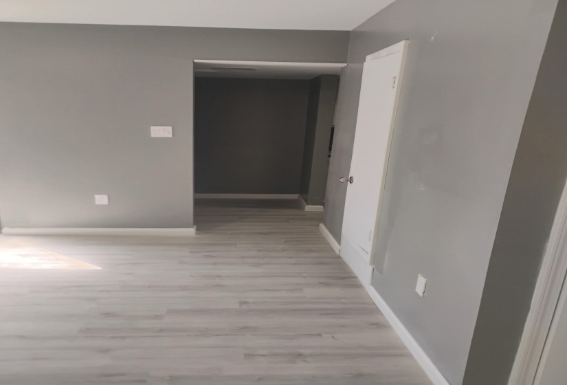 Empty room with light wood-type flooring and baseboards