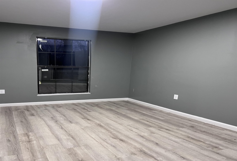 Empty room with light wood finished floors and baseboards