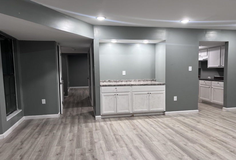 Interior space featuring baseboards and light wood finished floors