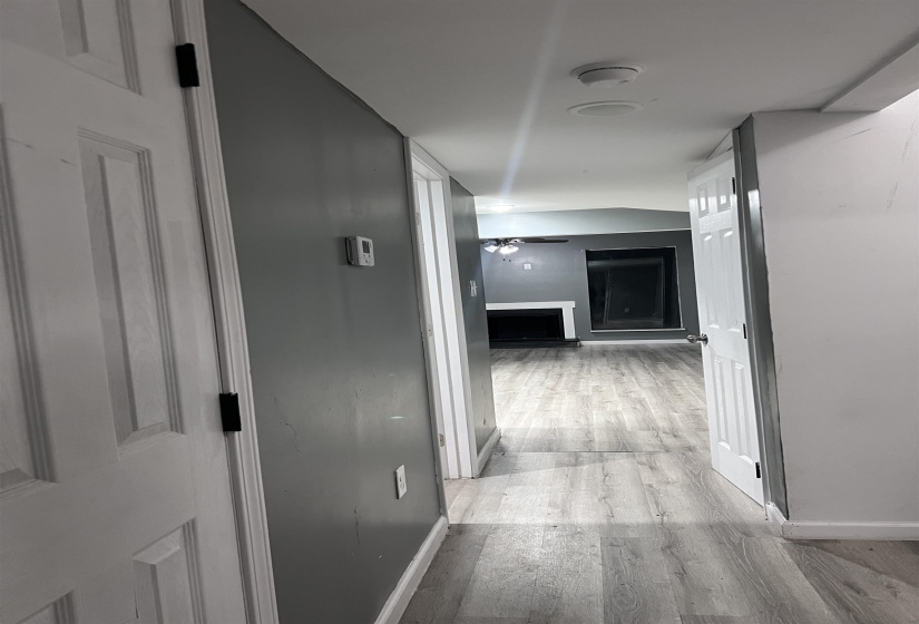 Hallway with light wood-style floors and baseboards