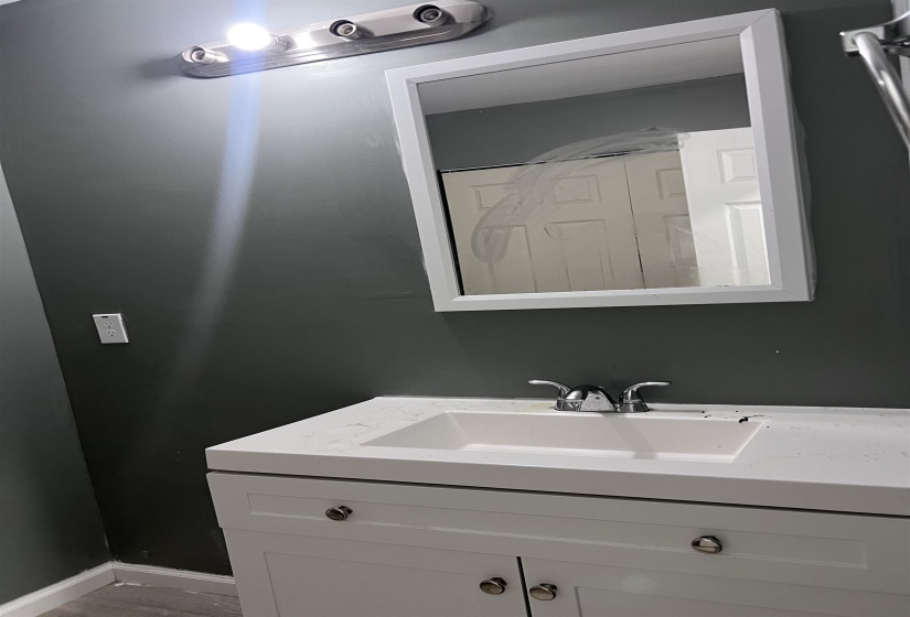 Bathroom featuring vanity and baseboards